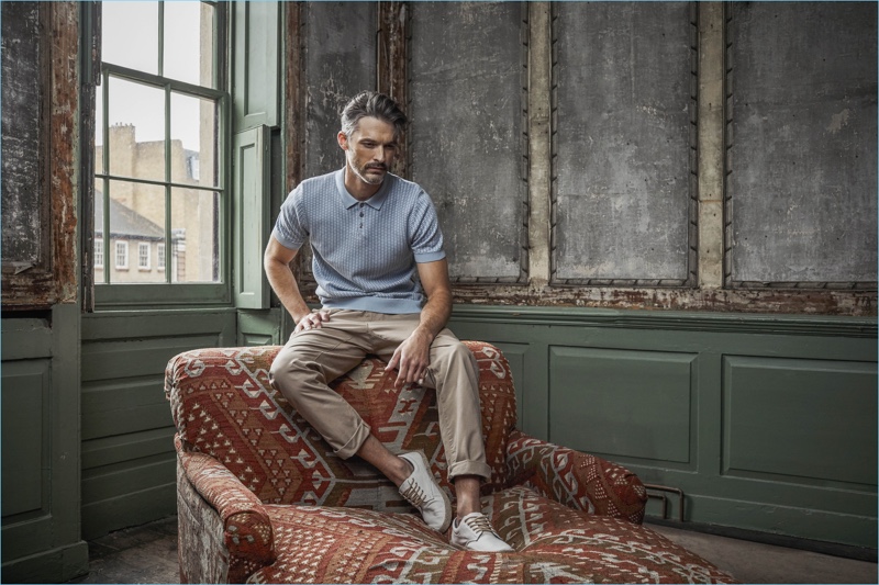 Embracing smart casual style, Ben Hill wears a polo with chinos and sneakers.