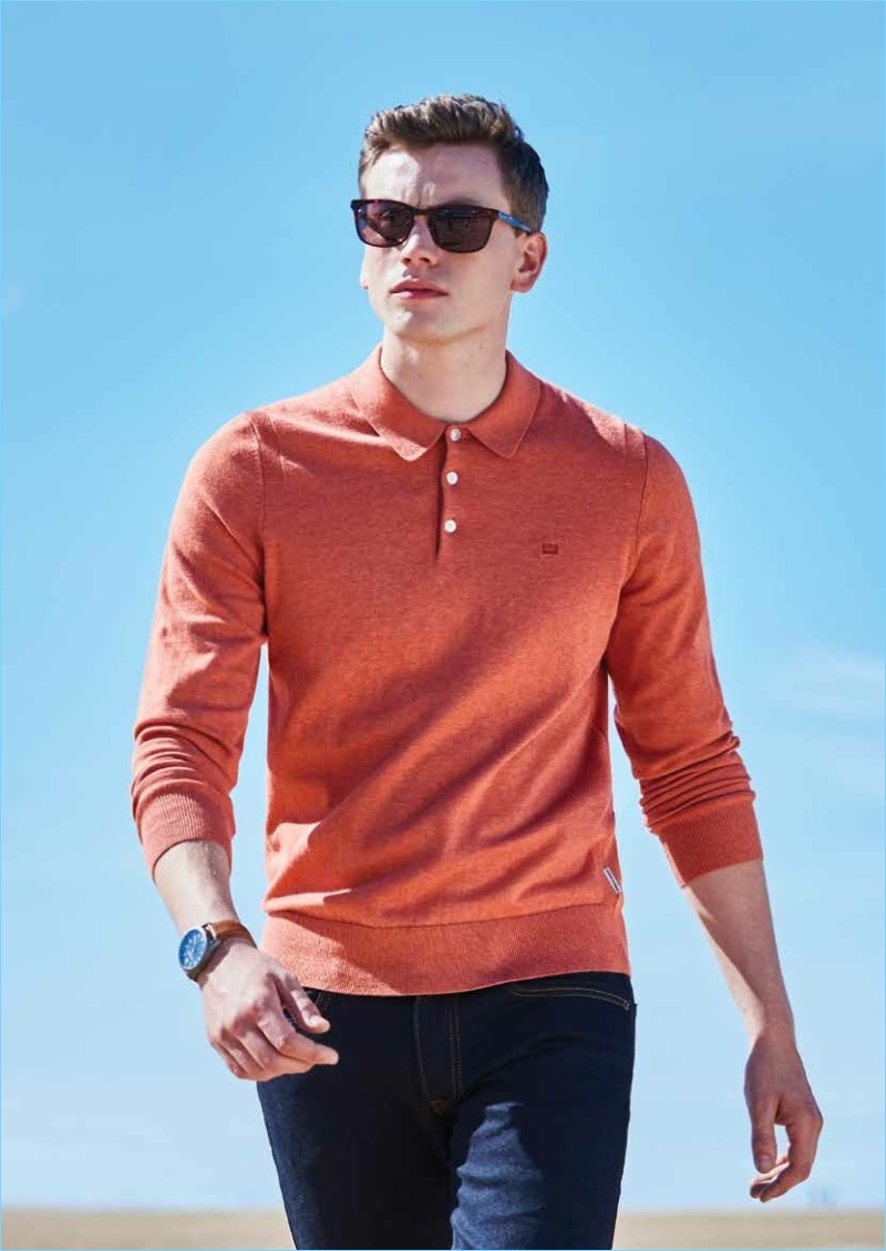 Model Sid Ellisdon sports a long-sleeve polo with dark wash jeans by Ben Sherman.