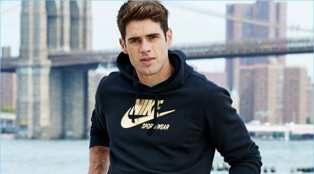 Chad White Goes Sporty in Nike Sweatshirt Chad White sports a Nike metallic logo sweatshirt from Macy's.