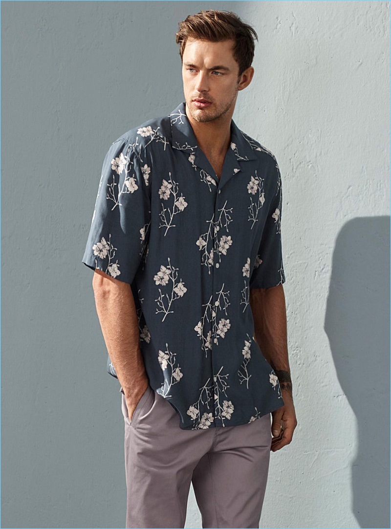 Going casual, Christian Hogue wears a floral print shirt and joggers by LE 31.