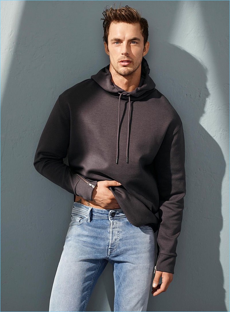 Model Christian Hogue rocks a LE 31 zip-sleeve hoodie with Jack & Jones skinny fit jeans.