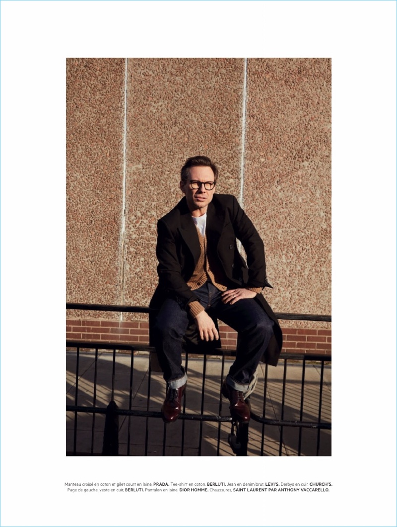 Connecting with L'Officiel Hommes Paris, Christian Slater wears a sweater and coat by Prada. He also sports a Berluti t-shirt, Levi's jeans, and Church's shoes.