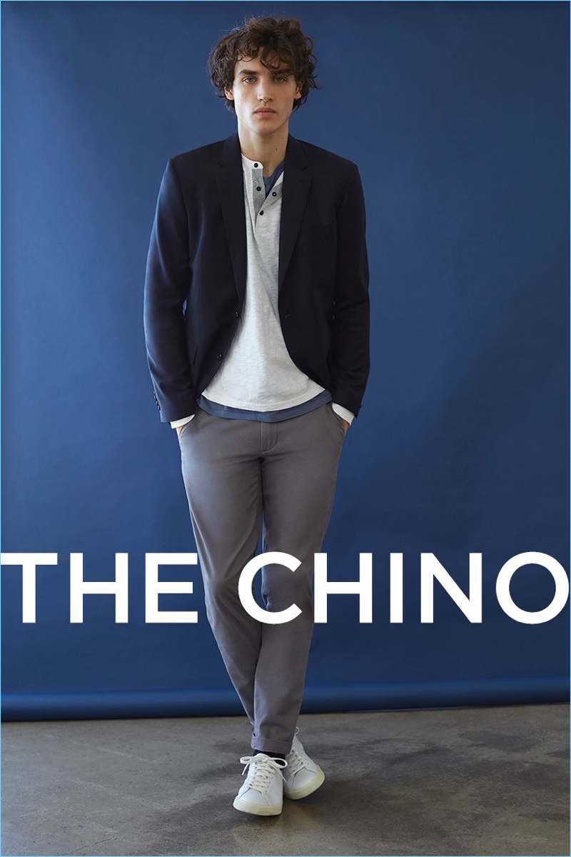 Chinos make for great everyday wear. Here, the chinos complement a henley, suit blazer, pocket tee, and Veja sneakers.