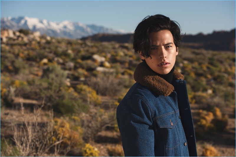 A striking vision, Cole Sprouse wears a denim jacket and turtleneck sweater by AMI.