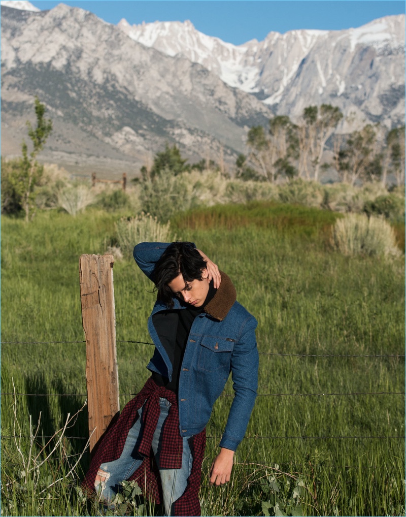 Taking to nature, Cole Sprouse wears a denim jacket and sweater by AMI. The Riverdale star also sports a Gucci shirt and jeans.