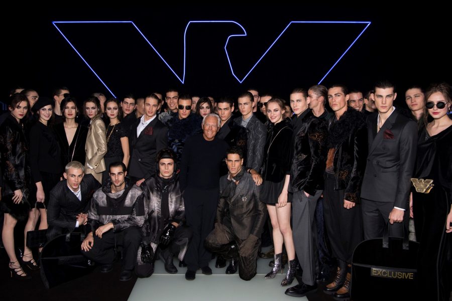 Giorgio Armani poses for pictures with the models that walked his fall-winter 2018 show for Emporio Armani.