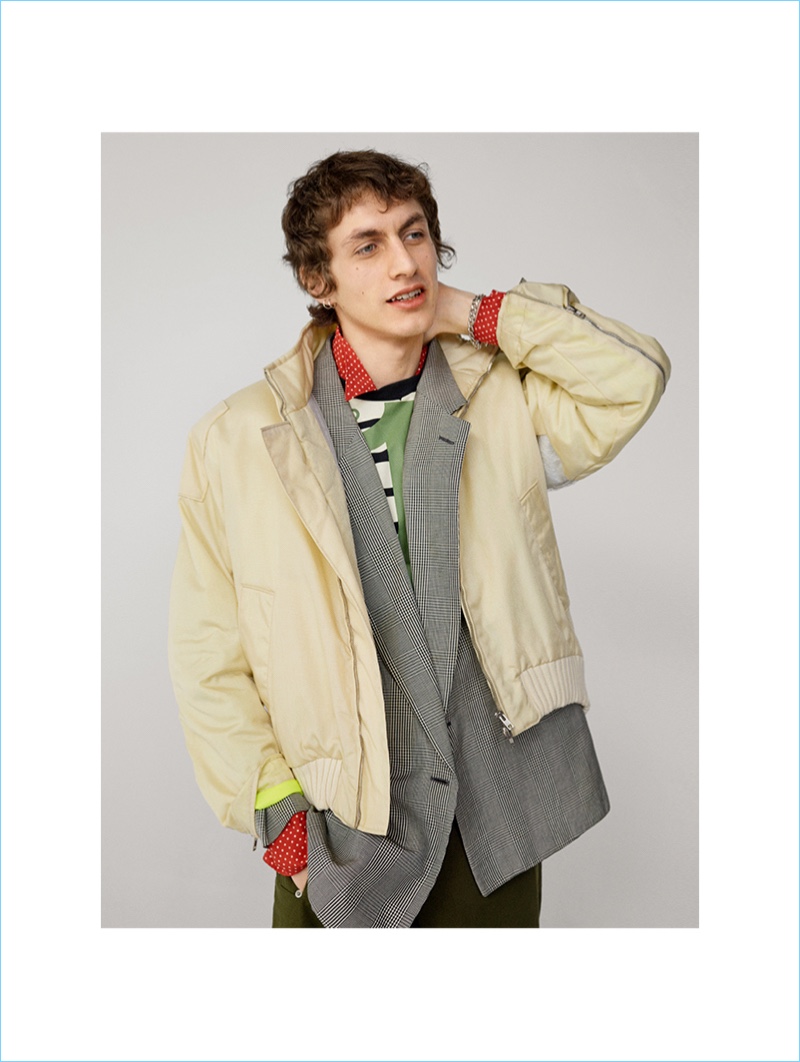 Henry wears bomber jacket and trousers, both by Walter Van Beirendonck from House of Liza, blazer (worn underneath) by Versace from A.N.G.E.L.O. Vintage, and T-shirt and shirt (worn underneath), both by Jean Paul Gaultier from House of Liza.