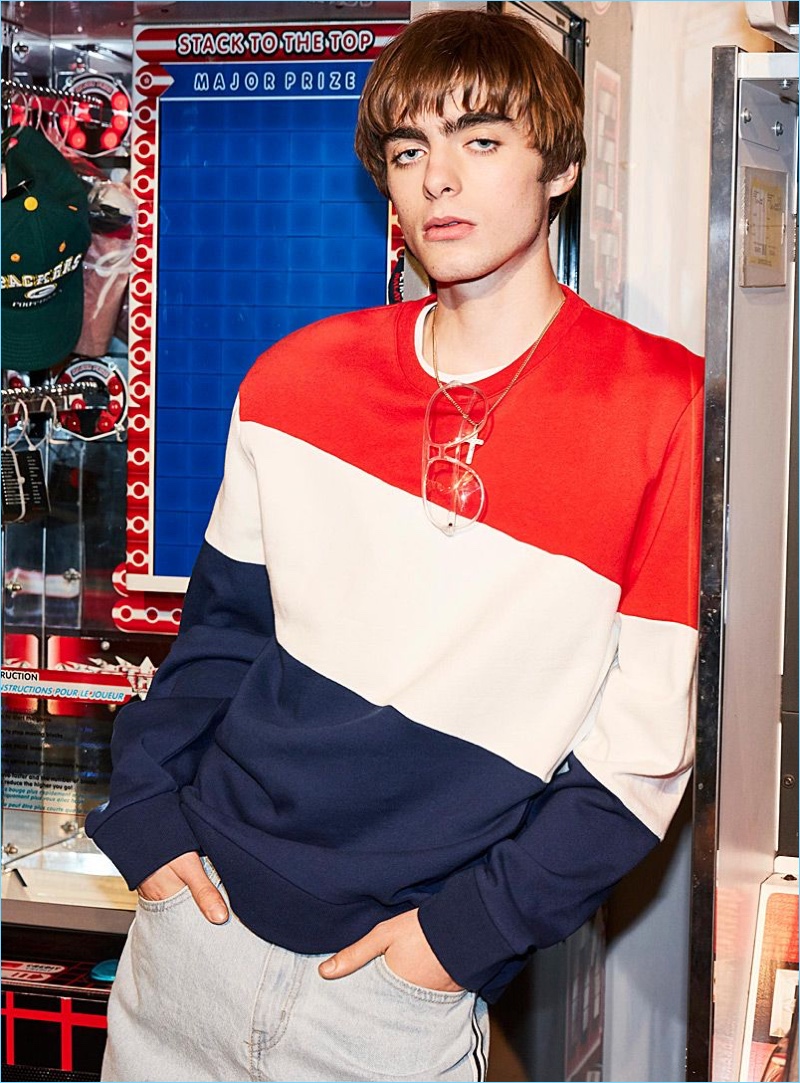 Lennon Gallagher sports a tricolor sweatshirt by DJAB with Triple J for Man tuxedo-stripe faded jeans.