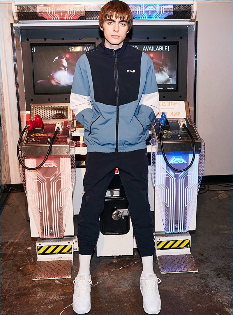 Model Lennon Gallagher wears a DJAB tracksuit with Nike Air Hurarache Run Ultra sneakers in white.