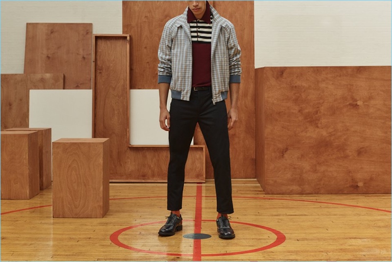 Prada offers a playful mix of patterns with a checked Harrington jacket, wool-flannel trousers, and a knit short-sleeve polo. It's styled with Prada wingtip brogues. 