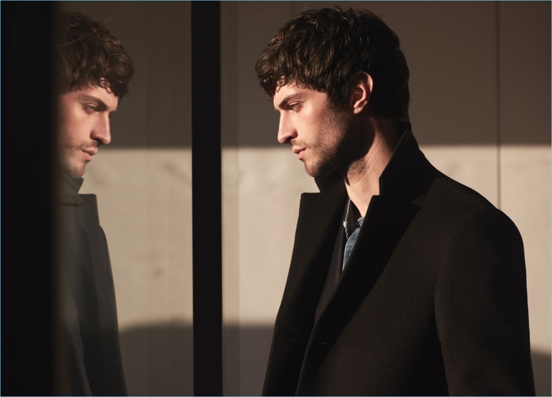 Matthew Bell dons a black overcoat with a denim grandad collar shirt by Reiss.