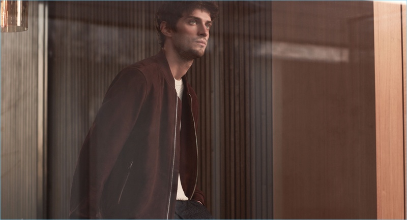 Making a case for suede, Matthew Bell wears Reiss' suede bomber jacket with a textured t-shirt and slim-fit trousers.