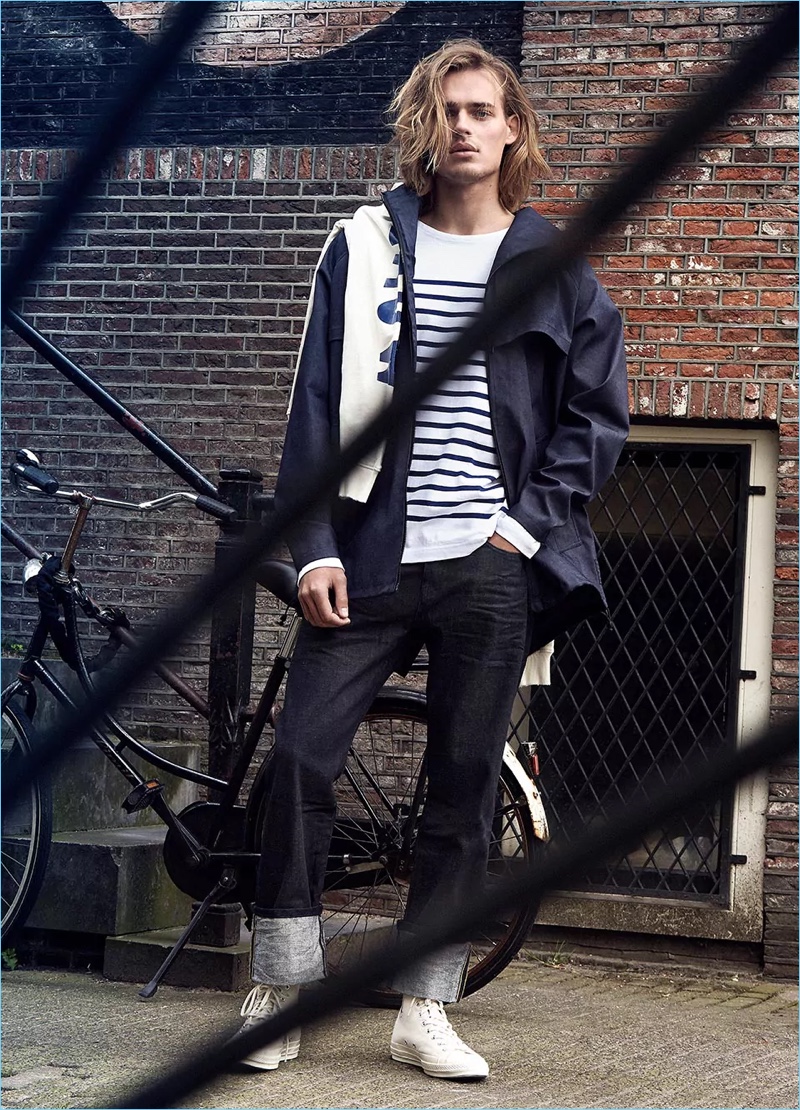 Showcasing nautical style, Ton Heukels wears a coated denim parka with a Breton striped t-shirt.