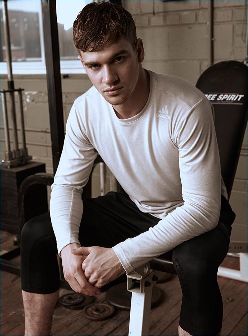 Model Matty Carrington wears an Adidas long-sleeve tee and capri joggers.