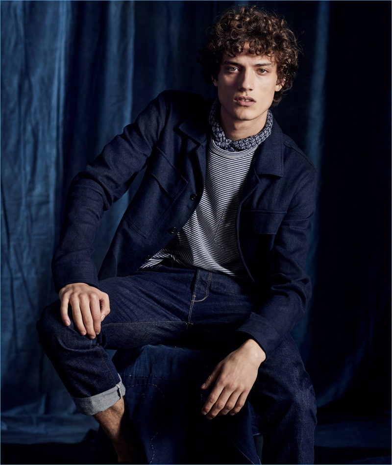 Todd Snyder highlights its linen cotton herringbone shirt jacket in navy. Here, Serge Rigvava wears it with the brand's striped pocket tee and indigo rinse jeans.