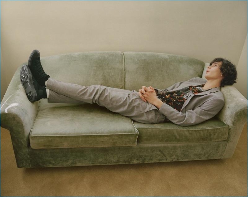 Lounging on a couch, Anton Jaeger dons a slim grey suit for Topman's spring 2018 campaign.
