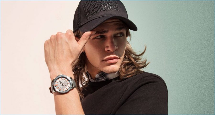 Cole Bollman shows off a new watch and cap from Armani Exchange.