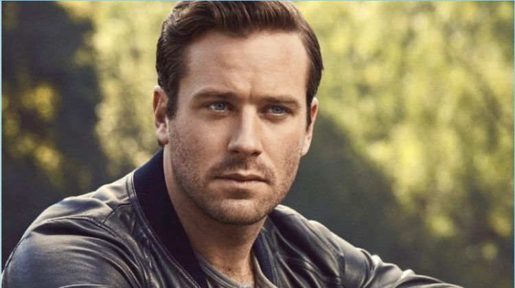 Starring in a new photo shoot, Armie Hammer wears a Dolce & Gabbana bomber jacket. He also rocks a H&M henley, Chopard watch, and Louis Vuitton pants.