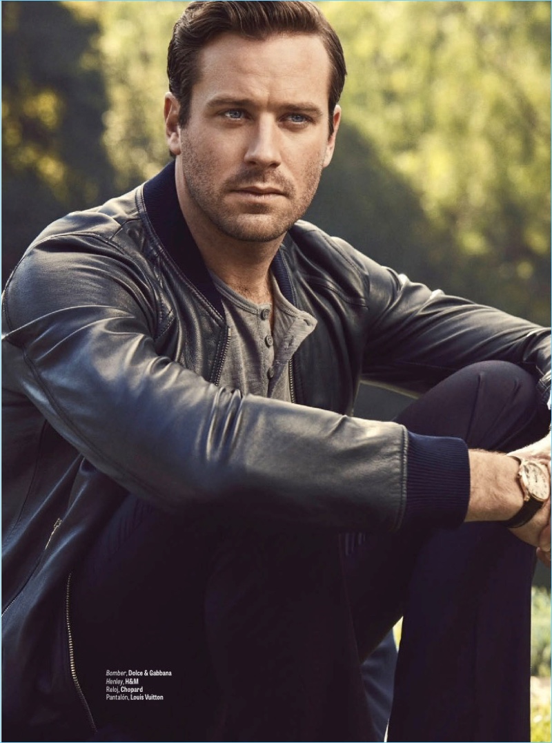 Starring in a new photo shoot, Armie Hammer wears a Dolce & Gabbana bomber jacket. He also rocks a H&M henley, Chopard watch, and Louis Vuitton pants.