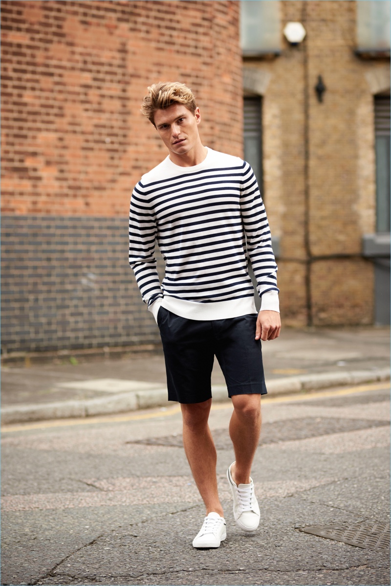 Donning a Breton stripe sweater and shorts, Oliver Cheshire wears a look by Autograph.