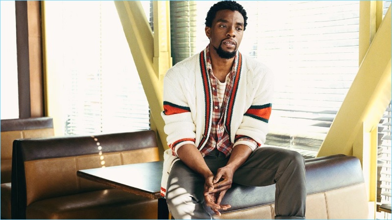 Embracing preppy style, Chadwick Boseman wears a Gucci cardigan with a Remi Relief flannel shirt. He also wears a Handvaerk striped t-shirt and Officine Generale chinos.