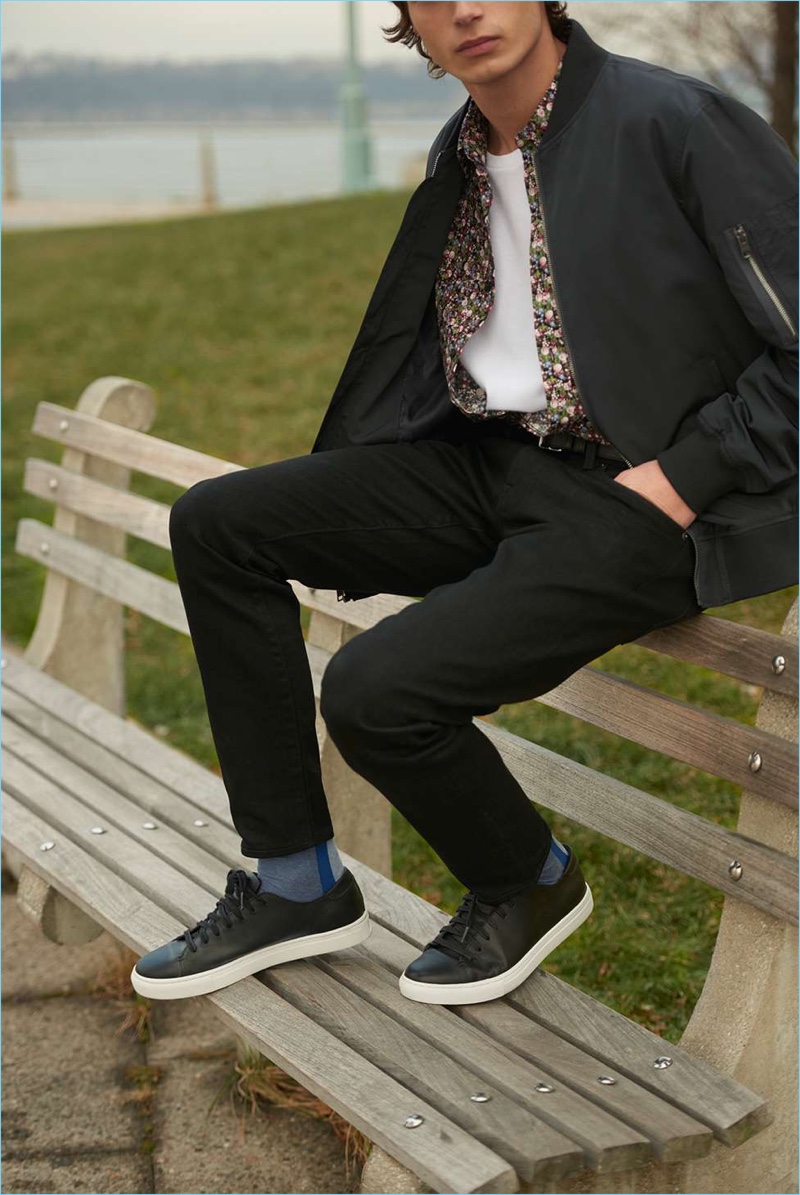 Complementing Club Monaco's timeless style, its new leather sneakers look great with the brand's black chinos. A bomber jacket, floral shirt, and pocket crew complete a must-try outfit.