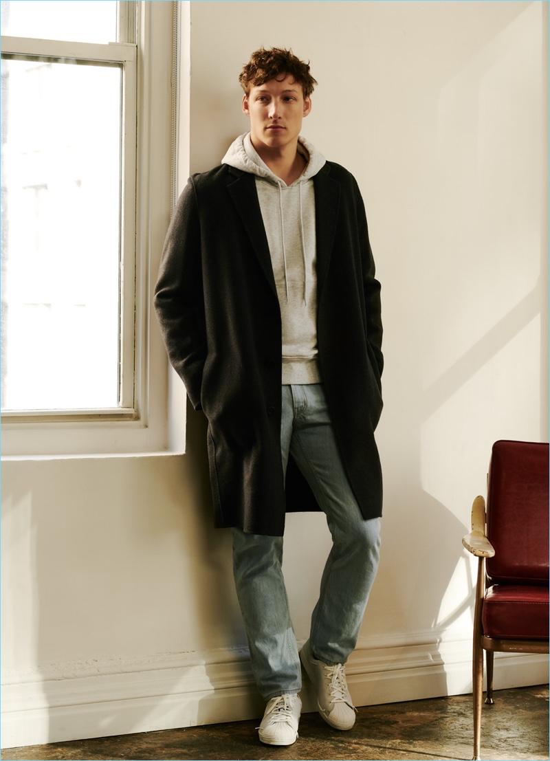 East Dane makes a case for the hoodie with a style from AMI. Here, it's worn with a Vince coat, Saturdays NYC jeans, and Y-3 sneakers.