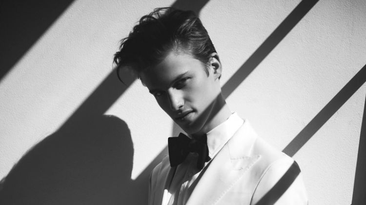 Donning a white tuxedo jacket, James Wyrick wears P Johnson Tailors.