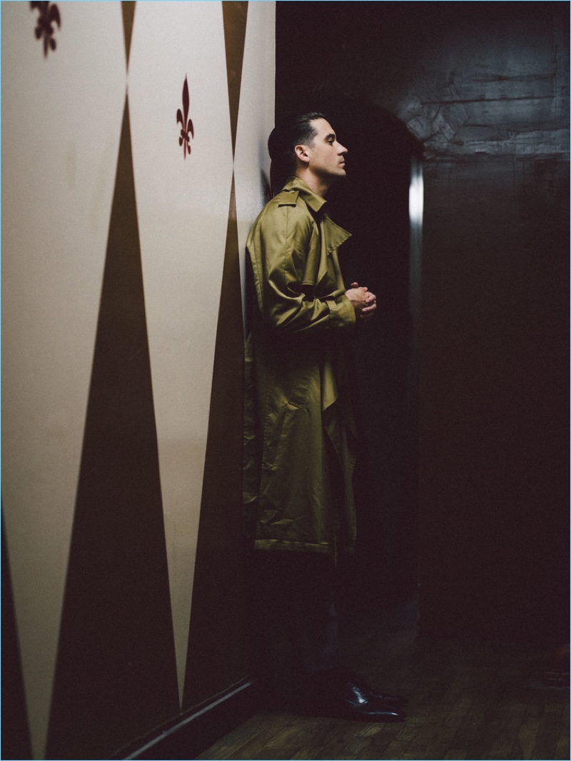 Delivering a side profile, G-Eazy wears a Louis Vuitton trench coat and trousers. He also sports Christian Louboutin shoes.