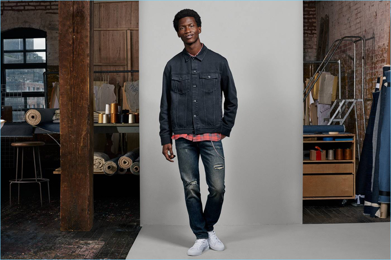 Adonis Bosso sports a denim jacket, flannel shirt, and slim-fit jeans from H&M.