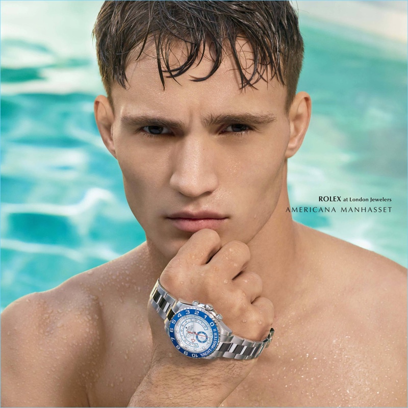 Emerging from the pool, Julian Schneyder sports a Rolex timepiece.