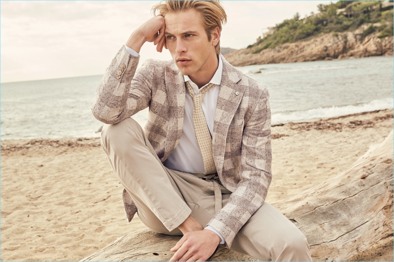 Taking to the beach, Jules Raynal wears a neutral hued suit from L.B.M. 1911.