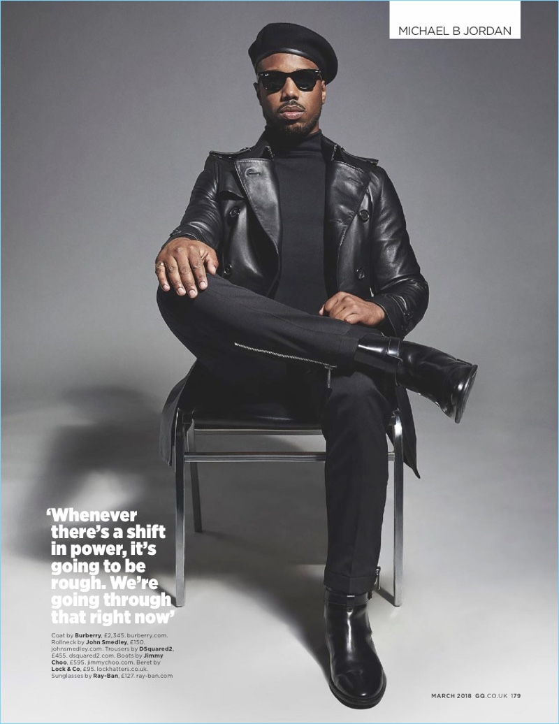 Black Panther actor Michael B. Jordan wears a leather Burberry coat with a John Smedley turtleneck. Jordan also sports Dsquared2 trousers, Jimmy Choo boots, and Ray-Ban sunglasses.