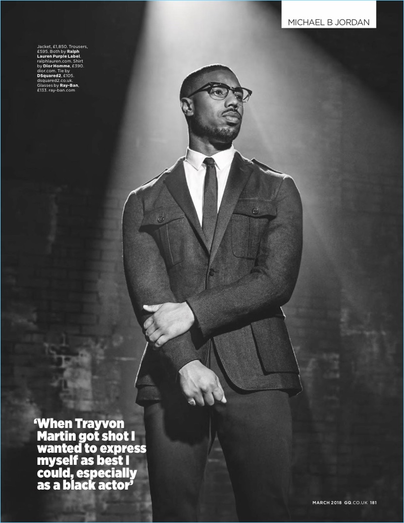 Standing at attention, Michael B. Jordan wears a jacket and trousers by Ralph Lauren Purple Label. The American actor also dons a Dior Homme shirt, Dsquared2 tie, and Ray-Ban glasses.