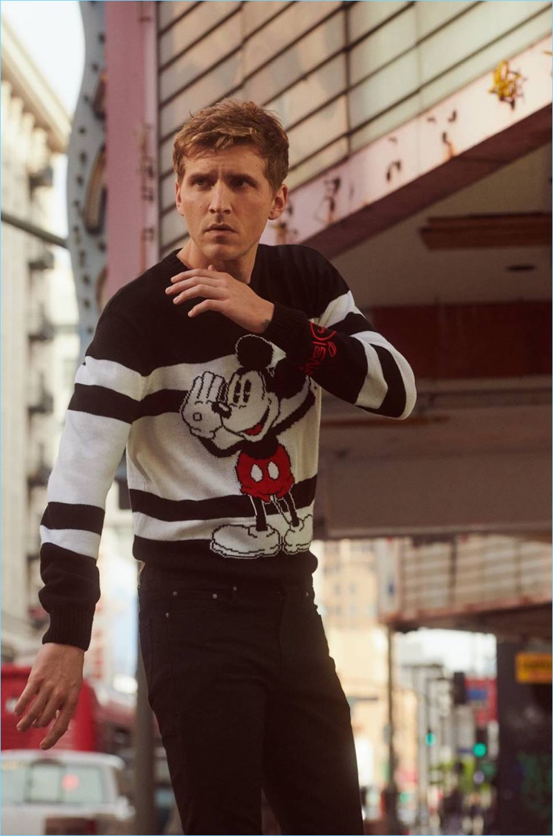 Making a case for Disney, Nathan Mitchell wears a Micky Mouse sweater and black skinny jeans.