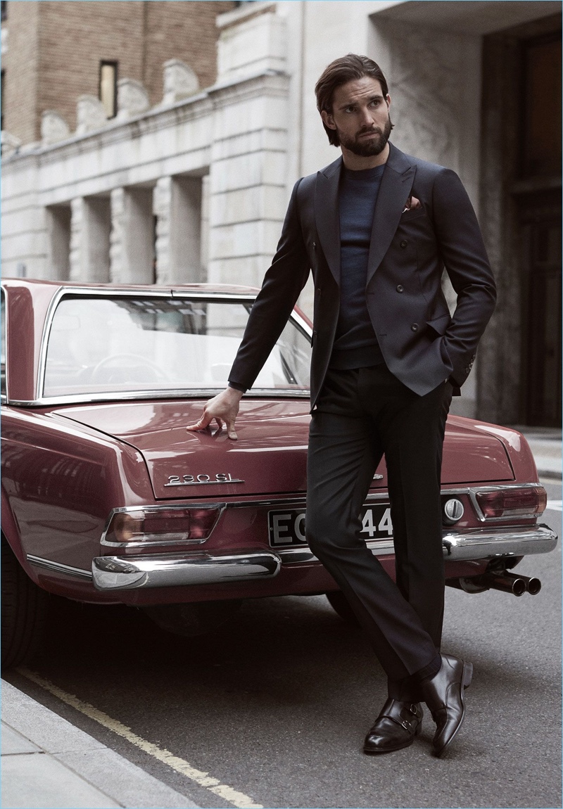 Stepping out in Reiss, Jamie Jewitt wears a double-breasted blazer, sweater, trousers, double monk strap shoes, and a patterned pocket square.