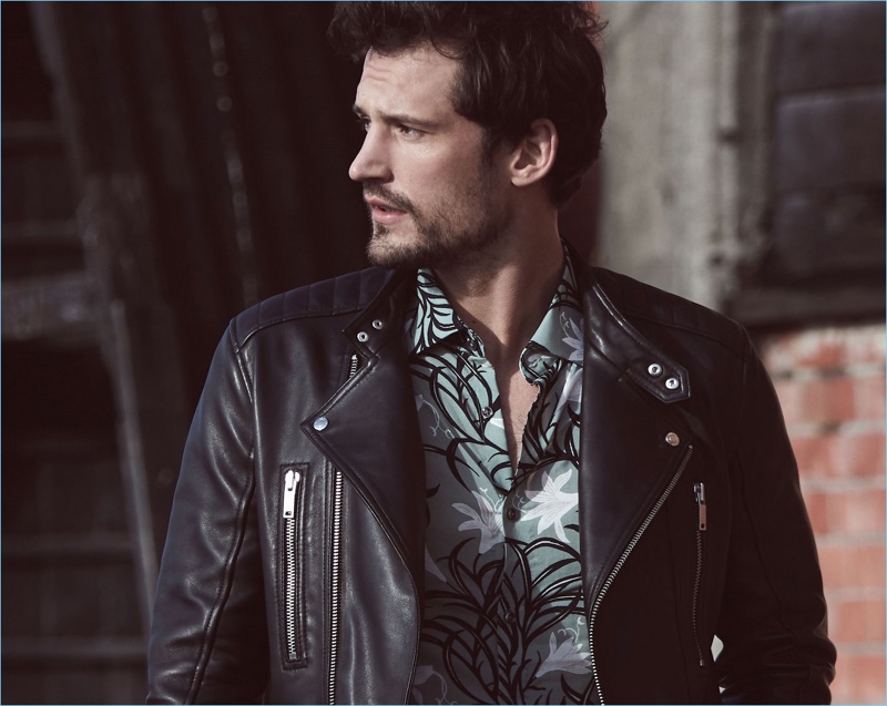 Sam Webb wears a quilted leather jacket and floral print shirt from Reiss.