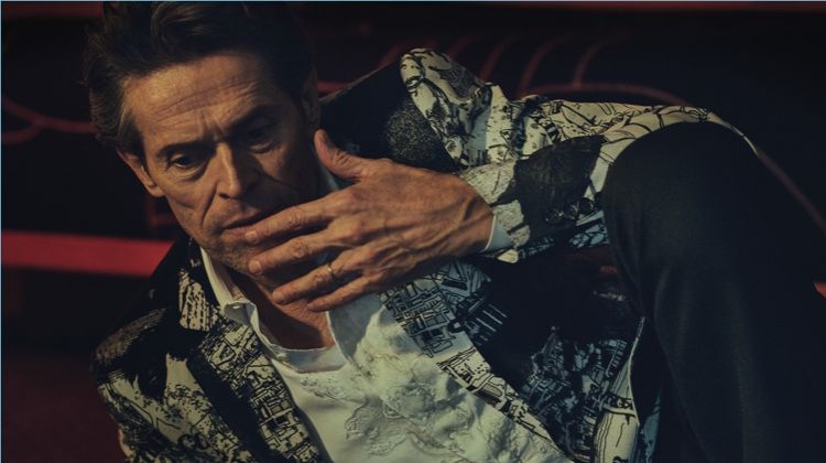 Connecting with Essential Homme, Willem Dafoe sports a dapper look from Alexander McQueen.