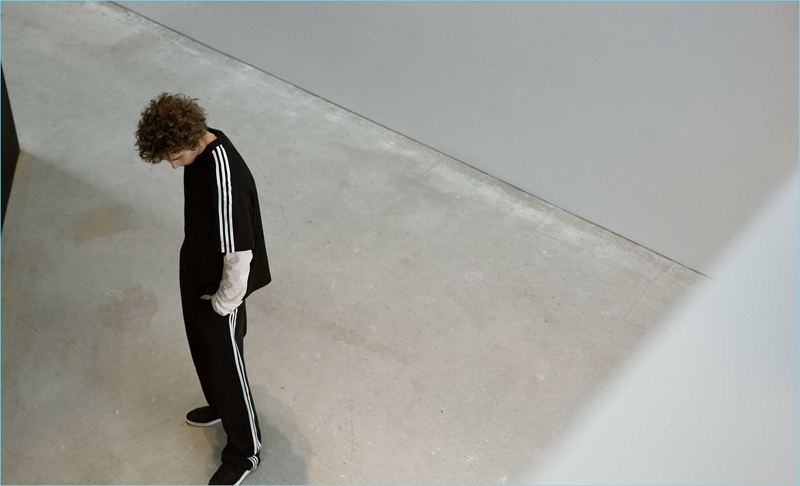 Starring in a Matches Fashion shoot, Mikołaj Kajak wears a Y-3 3-stripes jersey t-shirt, long-sleeved cotton t-shirt, wide-leg cotton-blend track pants and Suberou low-top neoprene trainers.