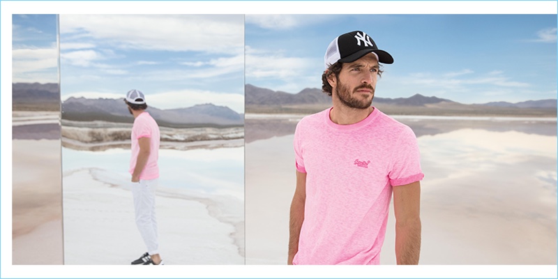 Going casual, Justice Joslin wears a Superdry t-shirt and New Era cap.