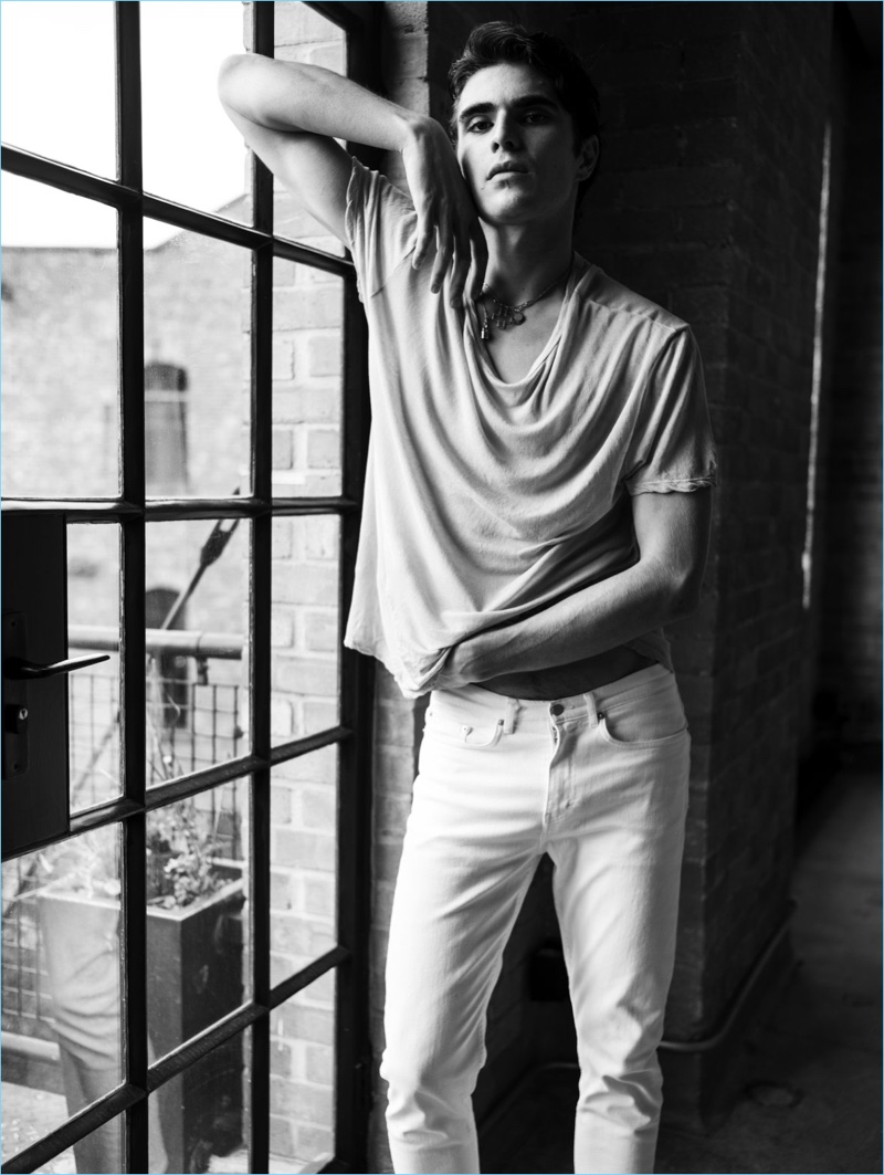 Rocking white denim jeans, Diego Villarreal fronts BLK DNM's spring-summer 2018 campaign.