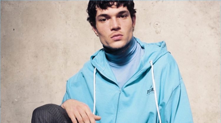 Model Luka Isaac sports a Balenciaga hoodie, Calvin Klein t-shirt, and Gosha Rubchinskiy trousers.