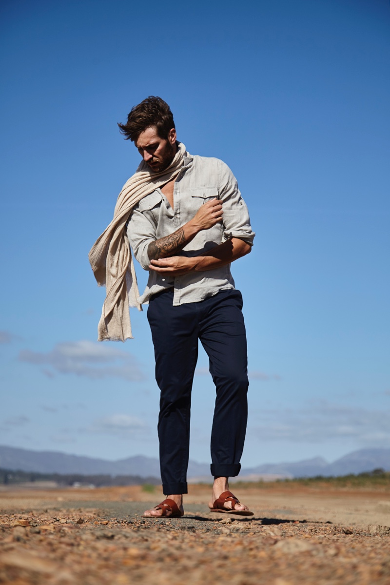 Benjamin wears scarf POLO Ralph Lauren, shirt Hermès, trousers Cerruti, and sandals Clarks.