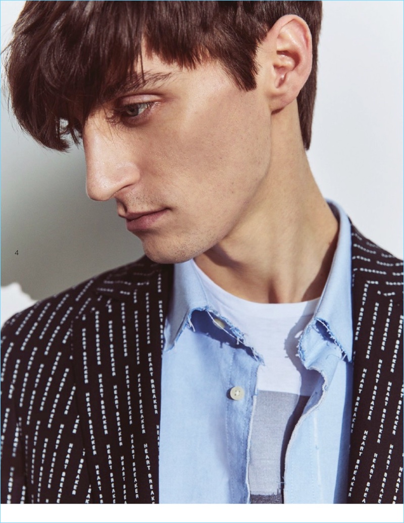 Ready for a close-up, Mihai Bran wears a "Heart Breakers" print blazer with a deconstructed shirt and graphic tee.