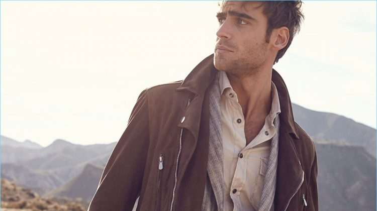 Neiman Marcus makes a case for layering with a look from Brunello Cucinelli. Here, George Alsford dons the brand's suede moto jacket with a striped linen sport jacket. A western style shirt and white denim jeans complete George's look.