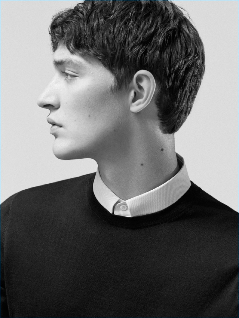 Delivering a side profile, Otto Lotz wears a COS pinstriped stretch-cotton shirt and cotton-silk knit top.
