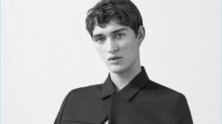 Otto Lotz wears a round-neck t-shirt, cotton-wool blend jacket, and slim-fit trousers with pleats by COS.