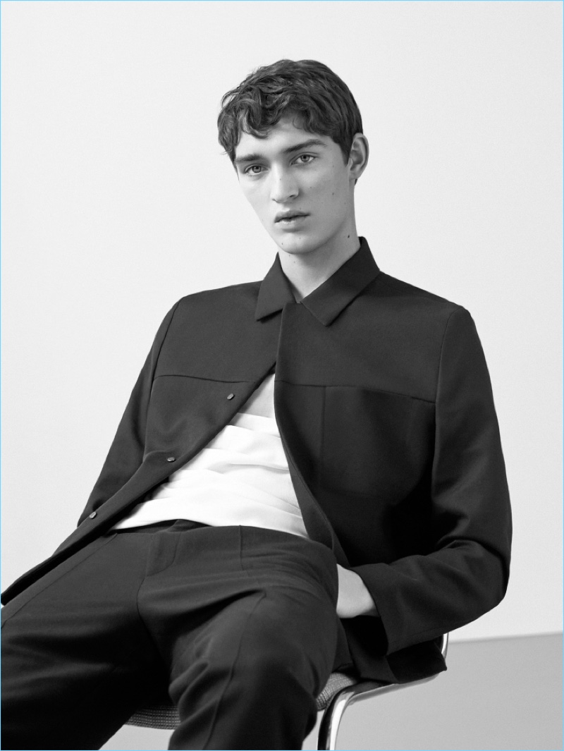 Otto Lotz wears a round-neck t-shirt, cotton-wool blend jacket, and slim-fit trousers with pleats  by COS.