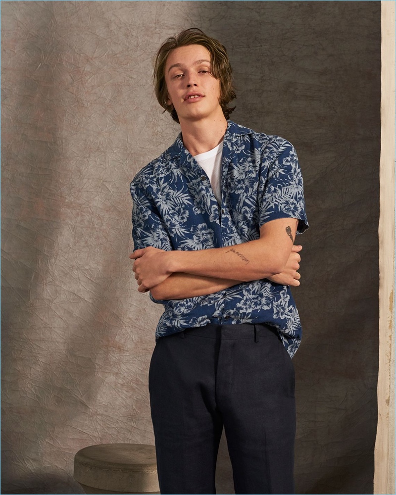 Wearing the latest trends from Club Monaco, Lucas Satherley wears a Hawaiian print shirt and trousers in linen.