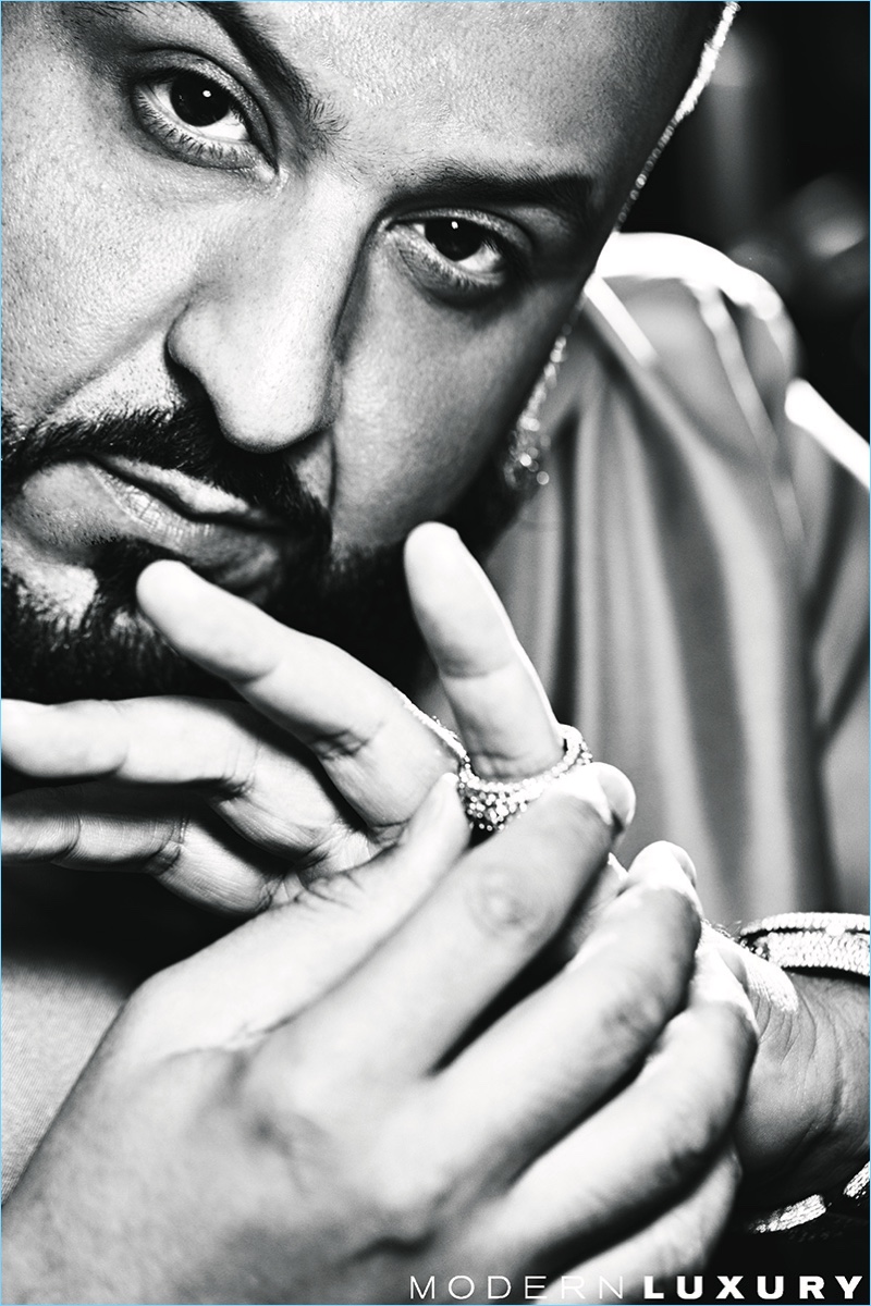 Starring in a photo shoot, DJ Khaled poses for a black and white image.